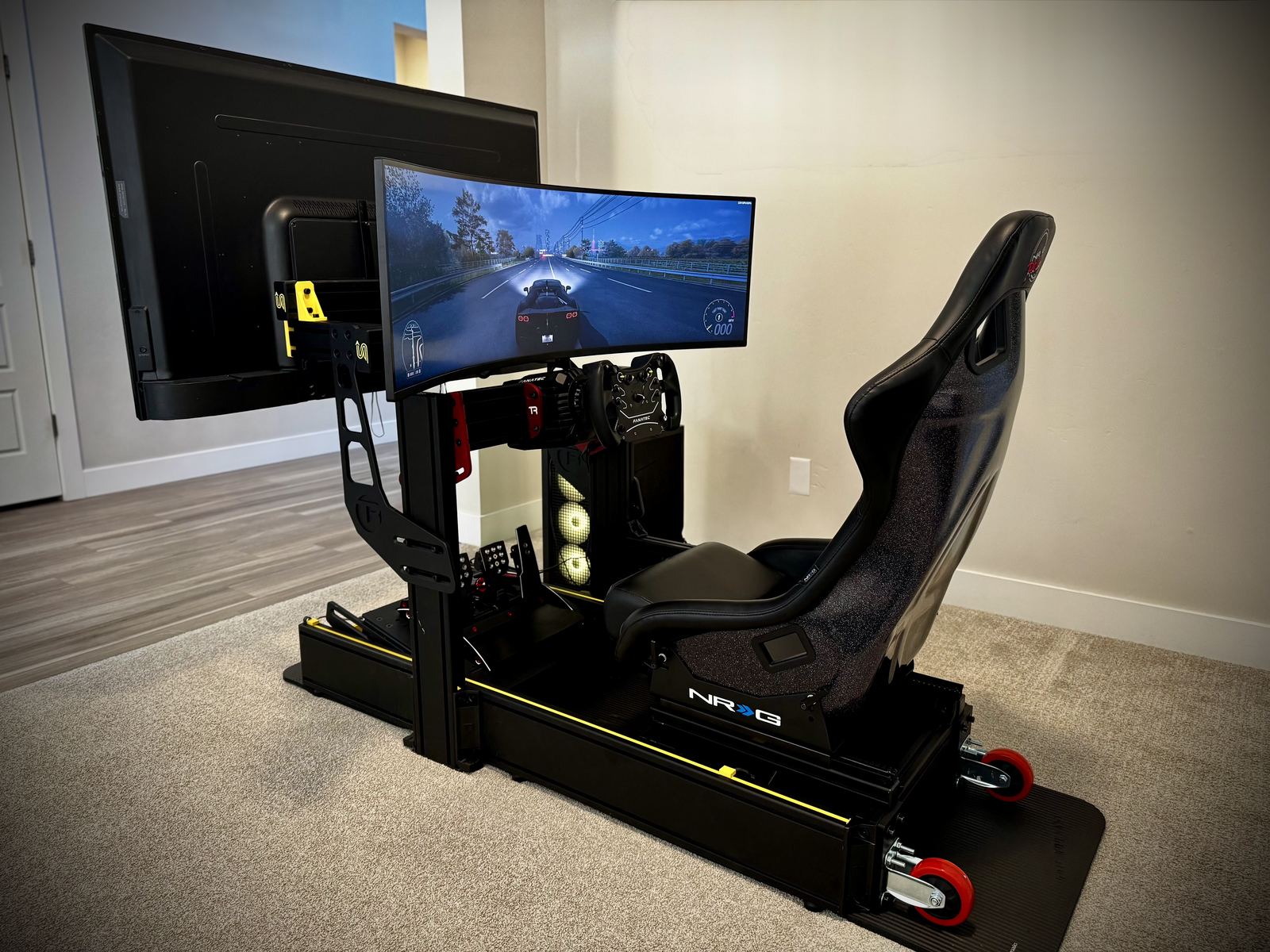 The Stinger sim racing rig set up in a living room, ready for a party
